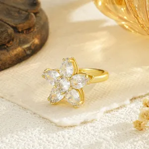 Detailed view of a gold-plated flower spinning ring with sparkling crystal petals.
