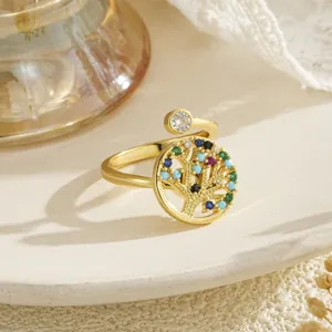Elegant close-up showing the intricate multicolor zircon inlay on the golden Tree of Life ring