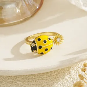 Close-up of a gold-plated ladybug and flower decompression ring with zircon