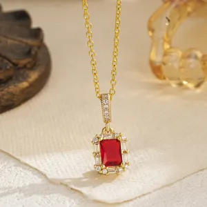 Detailed view of the vintage emerald cut red zircon necklace in an elegant gold setting