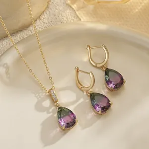 Close-up of vintage jewelry set featuring gradient teardrop gemstones and gold finish.