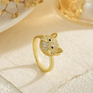 Close-up detail of a gold-plated cat head ring encrusted with sparkling cubic zirconia stones
