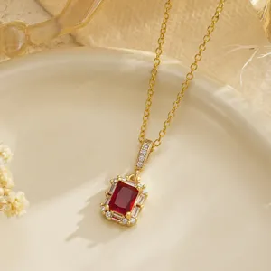 Detailed view of a vintage emerald-cut red ruby pendant necklace with zircon halo