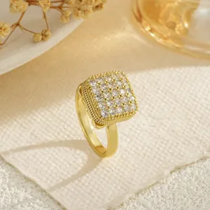 Macro view of a luxurious rotatable square gold ring pavé-set with sparkling cubic zirconia