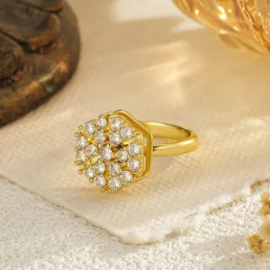Detailed macro shot of a gold-plated hexagonal rotating ring with sparkling zircons
