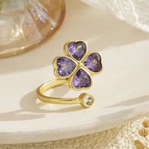 Close-up of rotatable four-leaf clover ring with purple heart-shaped zircons
