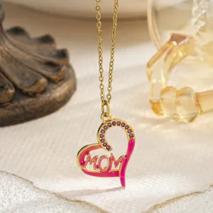 Close-up of heart-shaped MOM pendant featuring pink enamel and purple rhinestones detail