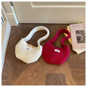 Close-up of off-white and red knitted mini handbags with egg. logo tags