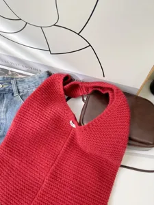 Close-up view of the high-quality red knitted texture on this large slouchy hobo tote bag