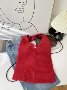 Detailed macro view of a red chunky knit tote bag with soft, cozy textile texture
