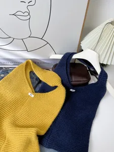 Close-up of vibrant yellow and navy blue knitted tote bags showing detailed woven texture