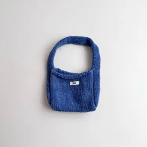 Close-up view of the soft blue knitted fabric texture on this stylish handbag