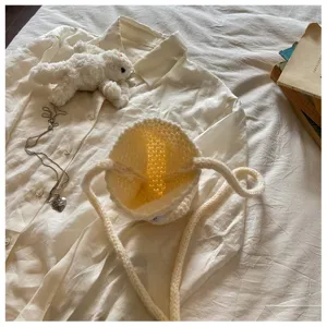 Interior view of cream hand-knitted mini crossbody bag showing detailed crochet texture