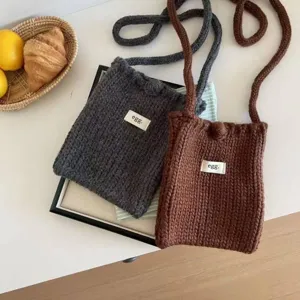 Handmade crochet crossbody mini bag for women in grey and brown wool, minimalist style