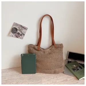 Small hollow cotton crochet beach bag shown with lifestyle props for size comparison.