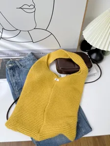 Detail of yellow knitted tote bag with soft woven texture in a lifestyle setting
