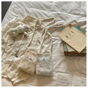 Small knitted crossbody phone bag and coin purse in cream and white colors for daily use