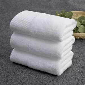 Set of three premium white pure cotton square towels with soft honeycomb woven texture