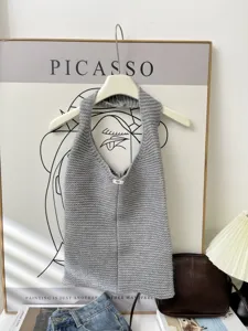 Detail view of a gray knitted tote bag with an egg label in a lifestyle setting.