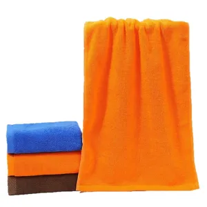 Set of soft absorbent pure cotton towels in orange, blue, and brown colors