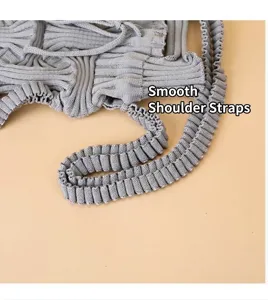 Close-up showing the pleated ribbed strap texture of a gray knitted crossbody bag