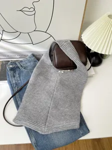 Close-up macro view of gray knitted tote bag with textured weave and spacious design.