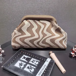 Close-up of wavy pattern knit cosmetic bag with frame closure and large capacity