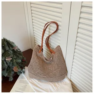 Close-up detail of a khaki crochet woven leisure beach bag featuring brown faux leather straps