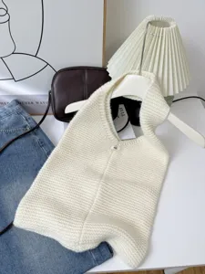 Detailed close-up showing the soft knit texture of a cream white oversized tote bag