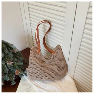 Detail view of a handmade crochet woven beach bag with brown leather shoulder straps