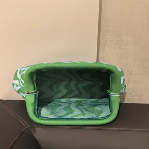 Detailed interior view of wave patterned knitted clutch bag showing spacious storage
