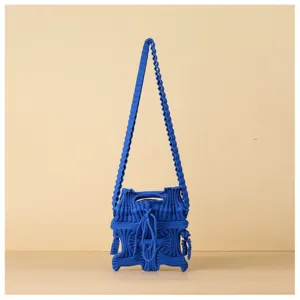 Detailed close-up showing the bright blue knitted texture of this pleated crossbody bag