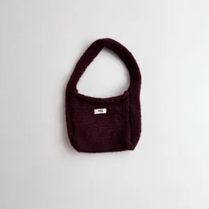 Dark burgundy knit handbag with minimalist egg label for stylish autumn and winter