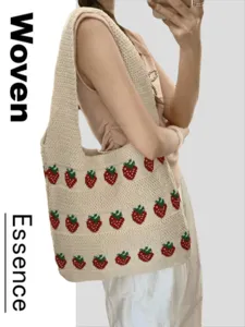 Crochet woven tote bag with cute strawberry pattern shown as shoulder bag accessory