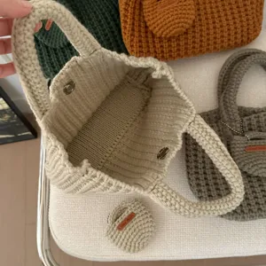 Close-up of vintage handmade knitted cotton tote showing interior with snap button