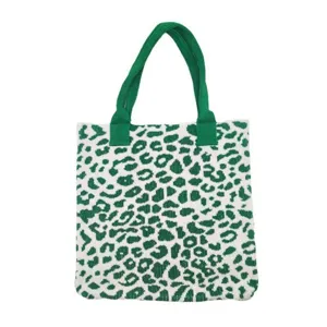 Detailed macro view showing green leopard print pattern on knitted tote bag fabric