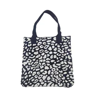 Modern knitted tote bag featuring a high-contrast black and white leopard print pattern