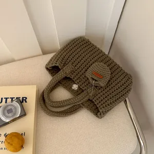 Close-up of a vintage handmade crochet shoulder bag in premium olive green cotton thread