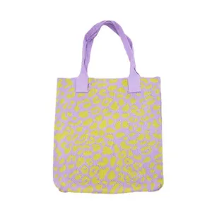 Close-up of a purple and yellow leopard print knitted tote bag with top handles