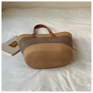 Large summer straw woven tote bag with black stripes and brown leather handles
