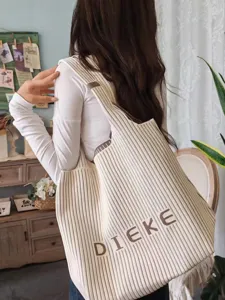 Large knitted pleated shoulder bag with DIEKE lettering shown in a lifestyle setting