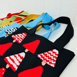 Detailed view of colorful knitted shoulder bags with woven Christmas tree design