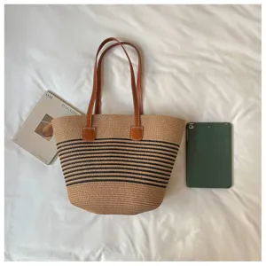 Large capacity summer woven straw tote bag shown next to a tablet for size reference
