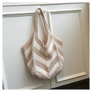 Close-up detail of the beige and cream chevron patterned crochet knit bag texture