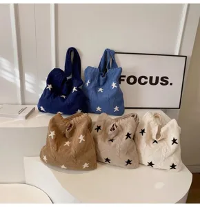 Detailed view of five stylish knitted tote bags with star patterns in various colors