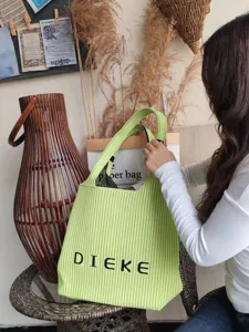 Vibrant lime green flyknit tote bag with DIEKE lettering and vertical pleated texture.