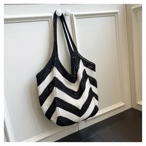 Close-up of black and white striped crochet tote bag showing woven texture