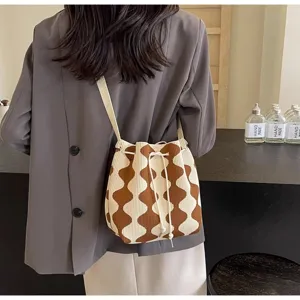 Fashionable brown and cream wavy pattern knit bucket bag with drawstring closure