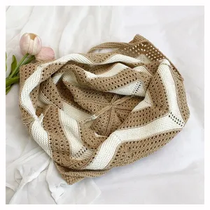Top view detail showing the texture of a large capacity striped crochet shoulder bag for women