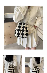Detail view of a black and white wavy pattern drawstring bucket bag on a model